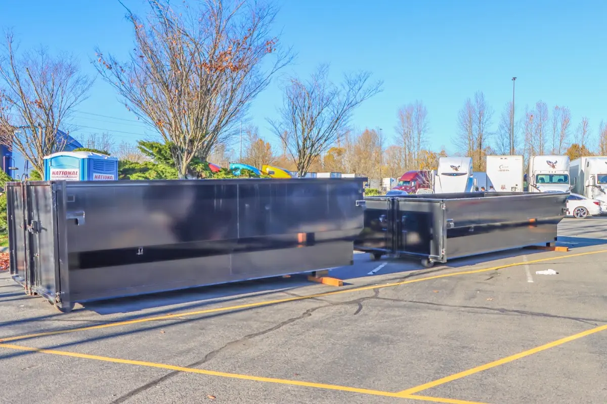 Professional dumpster rental service with roll-off container on residential driveway in Ellenton